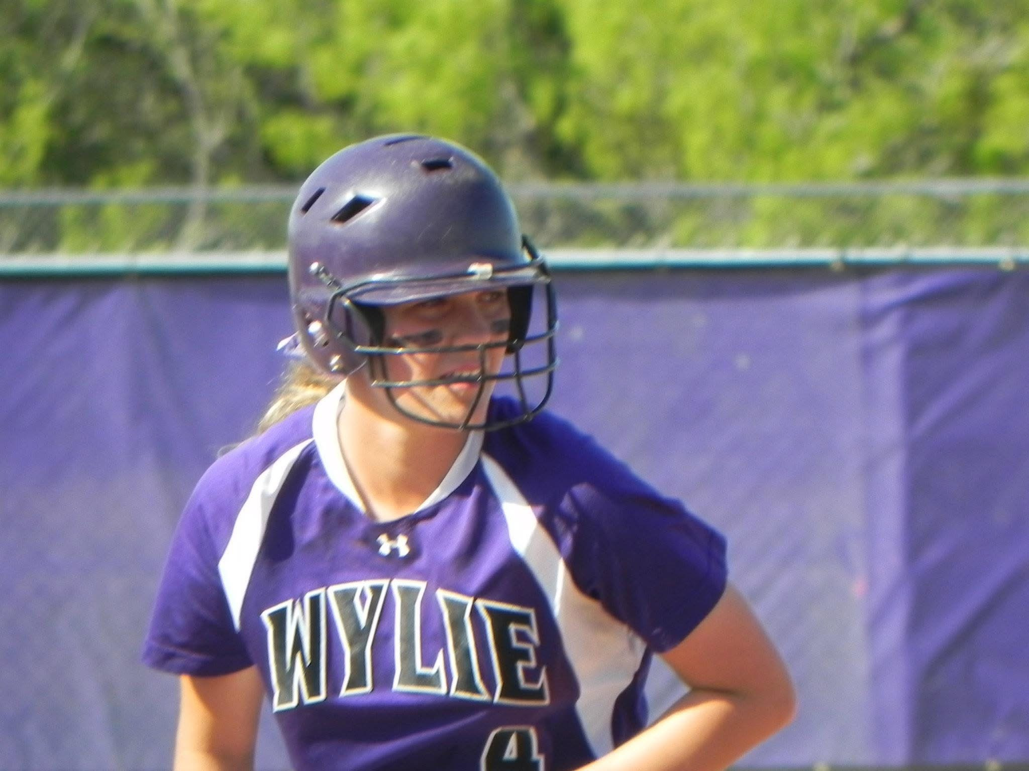 Brianna Halford standing on softball field with helmet on